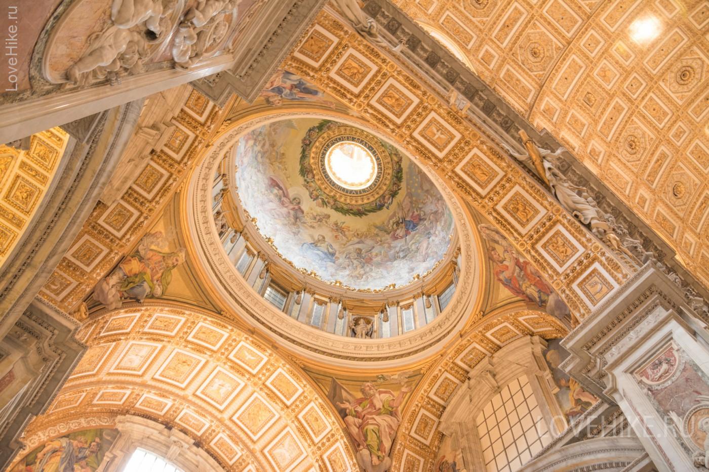 Vatican City, Rome, Italy - February 23, 2019: Interior ceiling of the Basilica of the Holy Apostle Peter in the Vatican, yellow color dome inside. Famous landmark in Rome.
